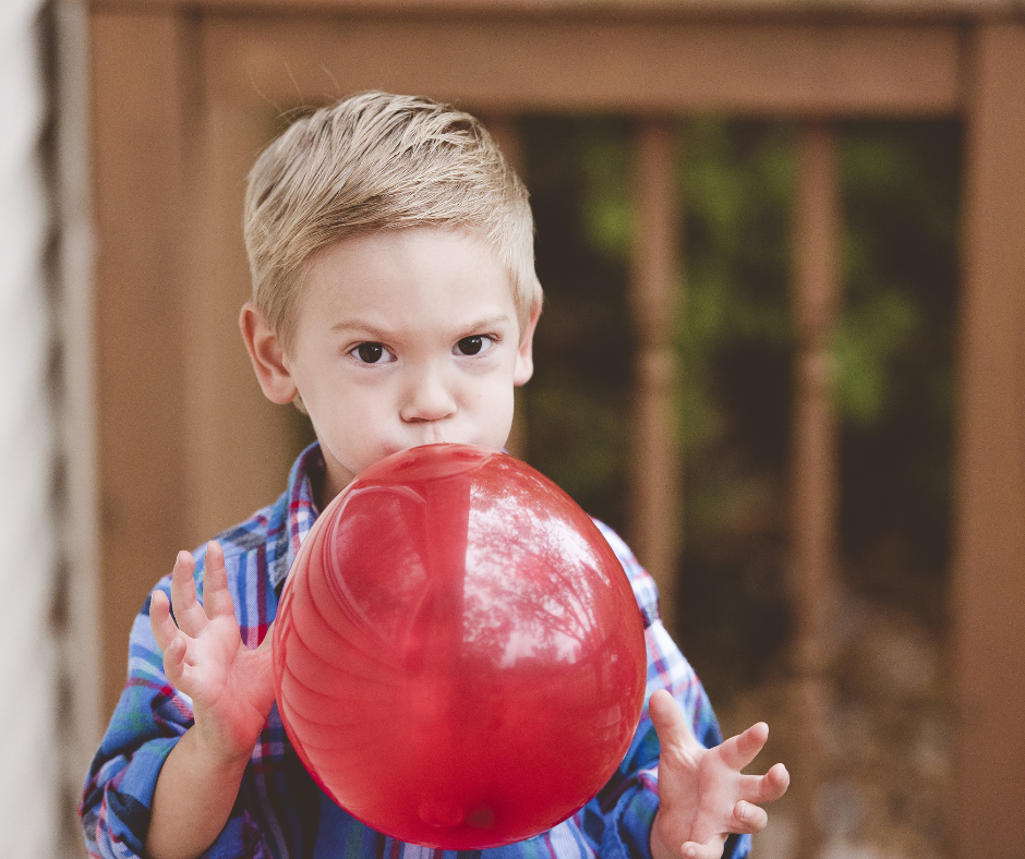 Child doing balloon breathing exercise 